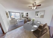 Thumbnail 1 of 19 - a living room with a dining table and a ceiling fan