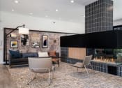 Thumbnail 6 of 44 - Lobby with a sofa and chairs and gas fireplace next to artwork
