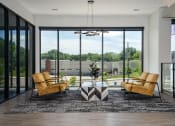 Thumbnail 10 of 44 - Lobby with chairs facing each other across a marble table and floor-to-ceiling windows