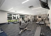 Thumbnail 11 of 44 - Fitness center with a variety of equipment and large windows