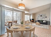 Thumbnail 1 of 17 - A dining room with a table set for six with a view of the backyard.
