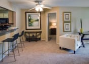 Thumbnail 21 of 23 - a living room with a couch and a dining room table