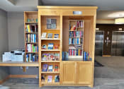 Thumbnail 17 of 25 - a bookcase filled with books in a living room