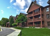 Thumbnail 24 of 26 - a large brick building with trees in the background