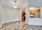 Thumbnail 3 of 26 - an empty living room with a kitchen in the background