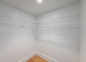 Thumbnail 17 of 22 - Empty white walk in closet with shelves.