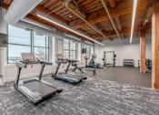 Thumbnail 9 of 22 - A gym with treadmills and other exercise equipment.