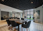 Thumbnail 8 of 76 - A modern dining room with a wooden table and chairs.