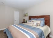 Thumbnail 10 of 20 - a bedroom with a bed and a white door at Sawgrass Apartments, Charleston, SC