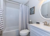 Thumbnail 20 of 20 - a bathroom with a shower and a toilet and a sink at Sawgrass Apartments, Charleston, South Carolina
