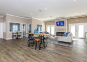 Thumbnail 12 of 20 - a living room with a couch and a table with chairs at Sawgrass Apartments, Charleston