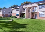 Thumbnail 1 of 20 - an apartment building with green grass in front of it at Sawgrass Apartments, Charleston