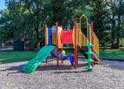 Thumbnail 3 of 20 - a playground with a slide and other toys in a park at Sawgrass Apartments, Charleston, South Carolina