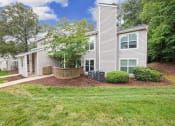 Thumbnail 12 of 19 - the front of a white house with a yard and trees at Chapel View Apartments in Chapel Hill, NC