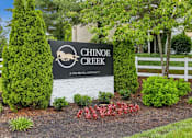 Thumbnail 25 of 25 - A sign for Chinook Creek in front of a white fence at Chinoe Creek Apartments, Kentucky, 40502