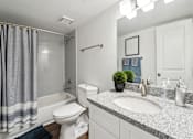 Thumbnail 28 of 31 - A bathroom with a white toilet, sink, and shower. at Linkhorn Bay Apartments, Virginia Beach, VA