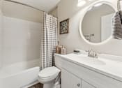 Thumbnail 20 of 22 - A white bathroom with a toilet, sink, and shower.