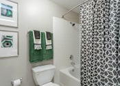 Thumbnail 20 of 26 - a bathroom with a white toilet next to a bathtub at The Resort At Lake Crossing Apartments, PRG Real Estate, Lexington, KY