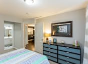 Thumbnail 18 of 26 - a bedroom with a bed and a dresser at The Resort At Lake Crossing Apartments, PRG Real Estate, Lexington, KY