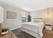 Thumbnail 21 of 22 - A bedroom with a large bed and a painting on the wall.