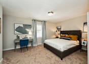 Thumbnail 19 of 19 - a bedroom with a bed and a desk and a window at Hyde Park Townhomes, PRG Real Estate Management, Chester, VA