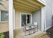 Thumbnail 12 of 25 - A small patio with a table and chairs is shown at Chinoe Creek Apartments, Lexington