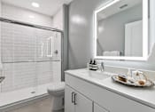 Thumbnail 8 of 43 - A white bathroom with a toilet, sink, and mirror at The Carousel, Richmond, VA