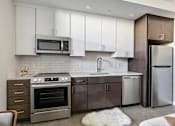 Thumbnail 2 of 43 - A modern kitchen with a stainless steel refrigerator and oven at The Carousel, Richmond, Virginia