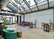 Thumbnail 26 of 43 - A room with a glass ceiling and a green chair at The Carousel Apartments, Richmond