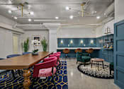Thumbnail 29 of 43 - A conference room with a long table and chairs at The Carousel Apartments, Virginia