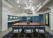 Thumbnail 28 of 43 - A dining room with a wooden table and chairs at The Carousel Apartments, Richmond, Virginia