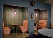 Thumbnail 16 of 43 - A room with a table, chairs and a wall decoration at The Carousel Apartments, Richmond, VA