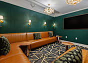 Thumbnail 18 of 43 - A room with a green wall and a brown leather couch at The Carousel Apartments, Richmond, 23220