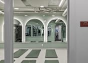 Thumbnail 22 of 43 - A yoga studio with green mats and mirrors on the wall at The Carousel Apartments, Richmond, 23220