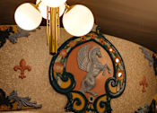 Thumbnail 12 of 43 - A chandelier with white globes hangs from a ceiling with a decorative mural at The Carousel Apartments, Richmond, 23220