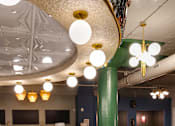 Thumbnail 10 of 43 - A bar with a curved counter and stools at The Carousel Apartments, Richmond, VA, 23220