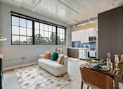 Thumbnail 45 of 51 - A modern kitchen with a dining table set for two at The Carousel Apartments, Richmond, Virginia