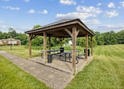 Thumbnail 30 of 32 - a pavilion with a picnic table in a park at The Grove at Lyndon, Louisville