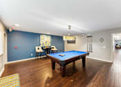 Thumbnail 11 of 25 - A pool table in a room with blue walls at Chinoe Creek Apartments, Lexington, KY, 40502