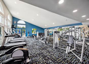 Thumbnail 9 of 25 - A gym with treadmills, weights, and exercise equipment at Chinoe Creek Apartments, Lexington, KY, 40502