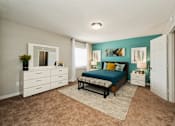 Thumbnail 14 of 19 - a bedroom with a bed and a dresser at Hyde Park Townhomes, PRG Real Estate Management, Chester, VA