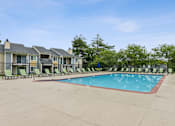 Thumbnail 7 of 25 - A swimming pool surrounded by lounge chairs and trees. at Chinoe Creek Apartments, Lexington, Kentucky
