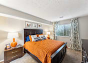 Thumbnail 20 of 25 - A bedroom with a bed, nightstand, and window at Chinoe Creek Apartments, Lexington 40502