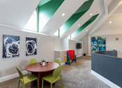Thumbnail 6 of 26 - a room with a round table and green chairs at The Resort At Lake Crossing Apartments, PRG Real Estate, Lexington, KY