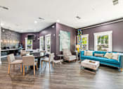 Thumbnail 11 of 26 - A living room with a purple wall and a blue couch at Proximity Apartments, South Carolina, 29414