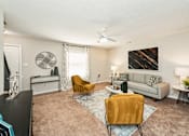 Thumbnail 18 of 19 - a living room with a couch and chairs and a ceiling fan at Hyde Park Townhomes, PRG Real Estate Management, Chester, VA