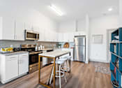 Thumbnail 13 of 26 - a kitchen with white cabinetry and stainless steel appliances at The Point Apartments on 38th, Norfolk, Virginia