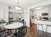 Thumbnail 25 of 31 - A modern kitchen with a dining table and chairs. at Linkhorn Bay Apartments, Virginia Beach