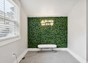 Thumbnail 18 of 31 - a living wall with a white bench in front of it at Linkhorn Bay Apartments, Virginia, 23451