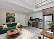 Thumbnail 33 of 43 - A living room with a green couch and a wooden coffee table at The Carousel Apartments, Richmond, 23220